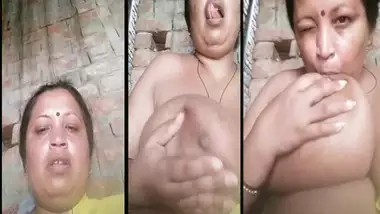 Mature Indian widow winks while sucking own big boobs